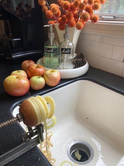 apple peeler/corer/slicer attached to sink and slicing an apple