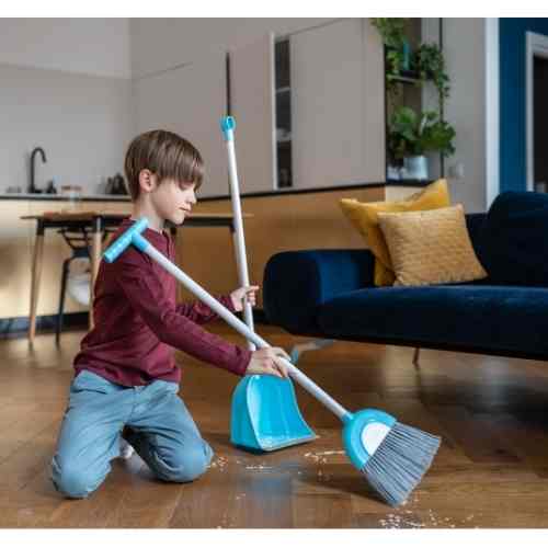 boy sweeping floor