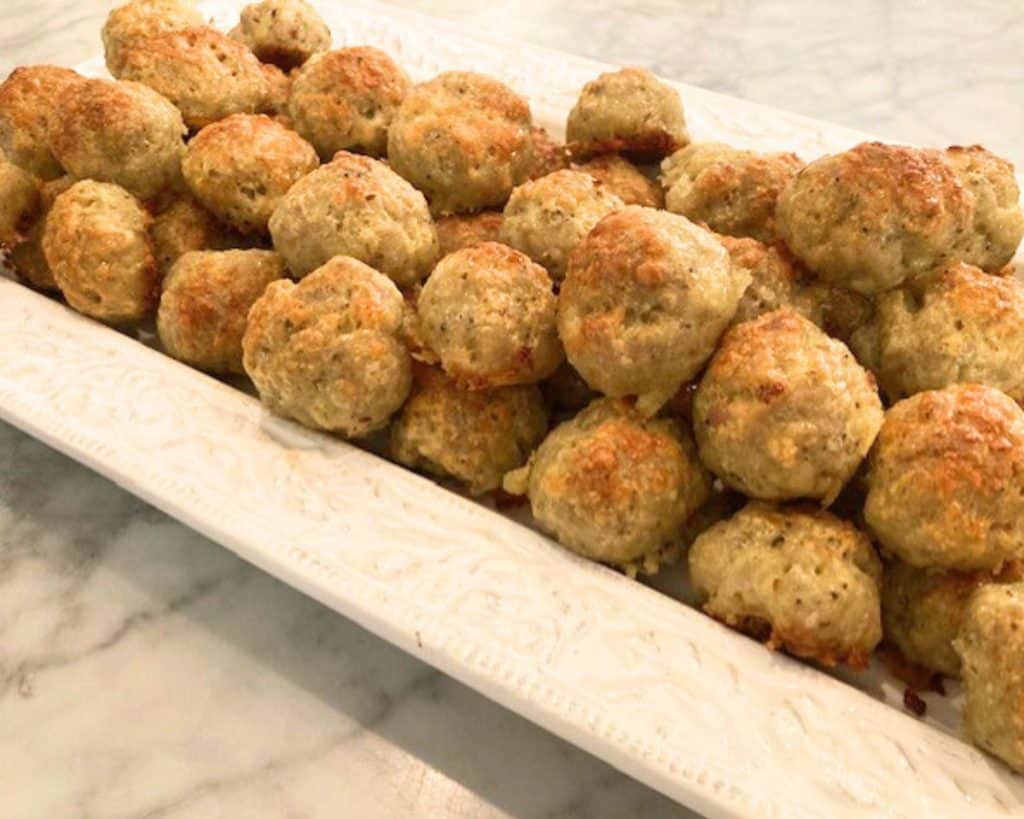 white tray with sausage balls piled up