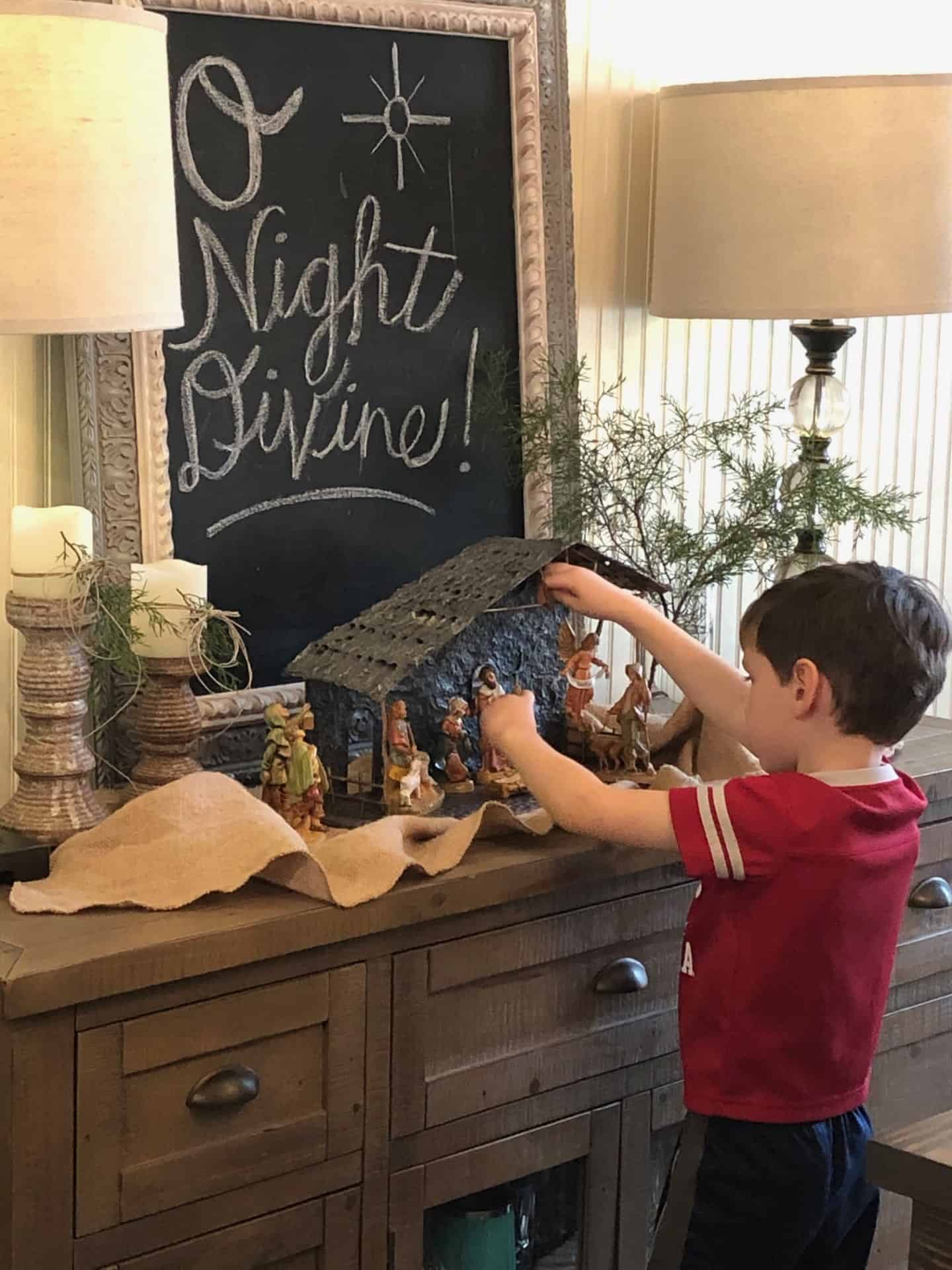 boy playing with nativity set