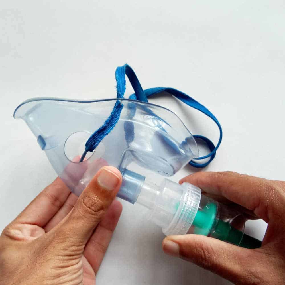 hand holding nebulizer mask