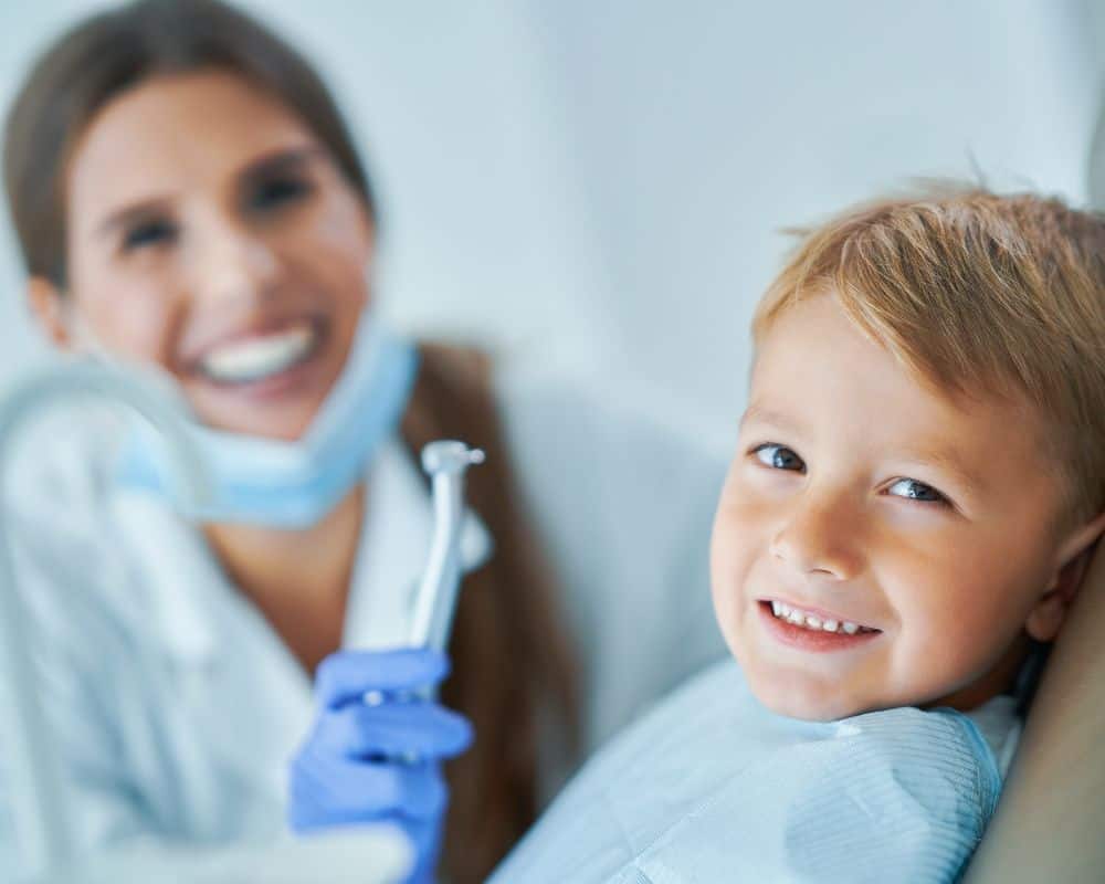 dentist and little boy smiling