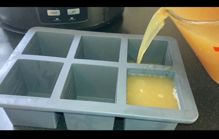 pouring broth into a silicone freezer mold