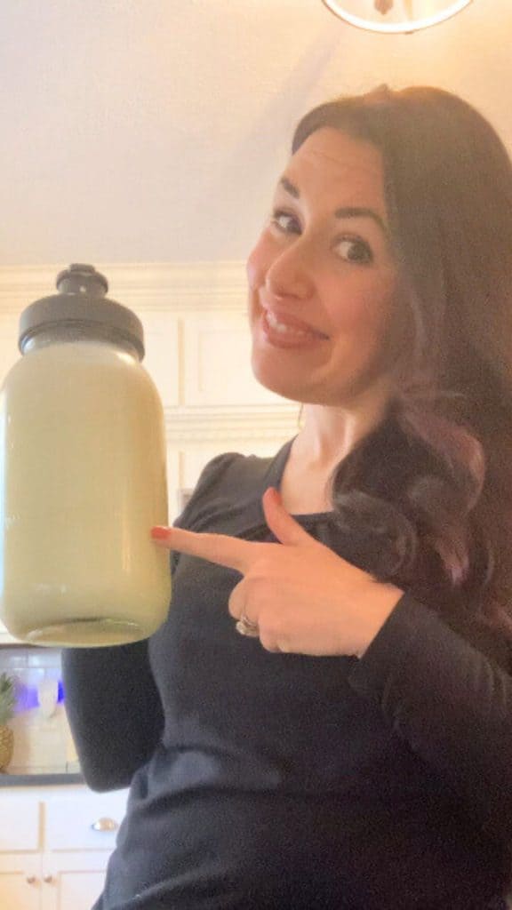 woman pointing to jug of raw milk