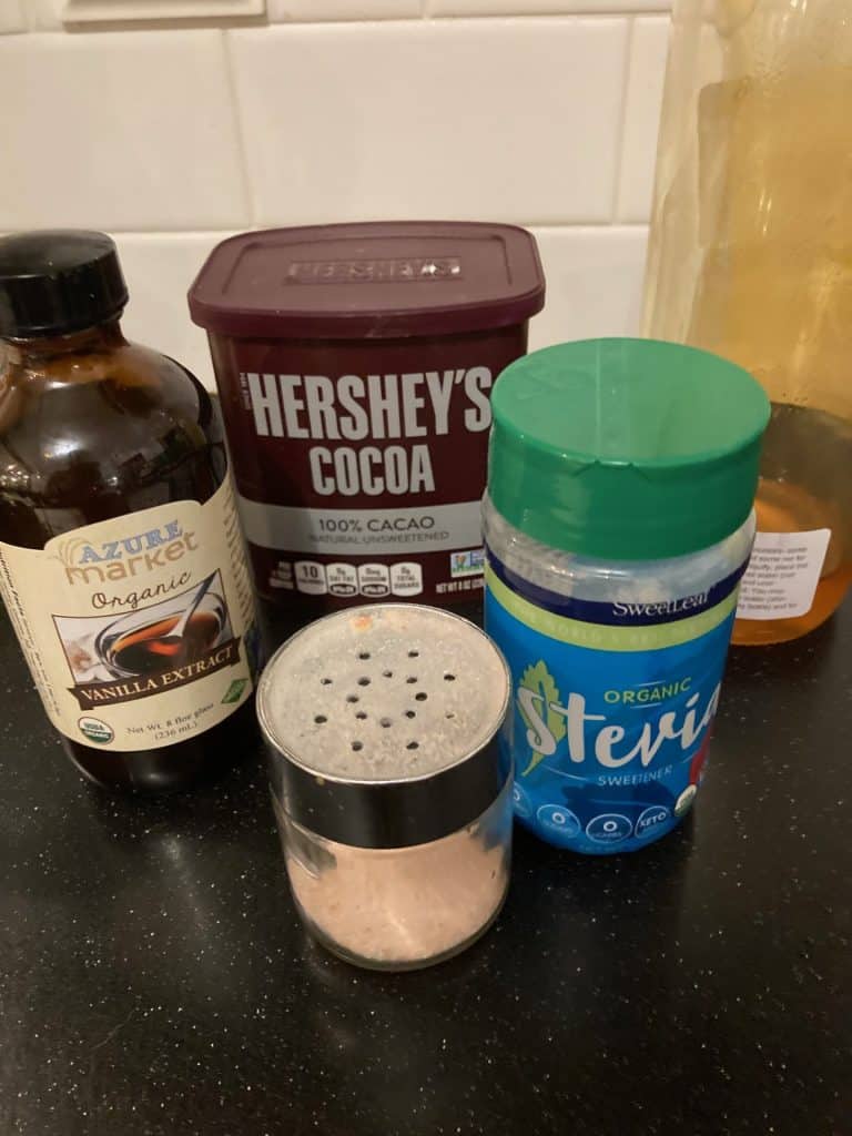 ingredients on counter: vanilla, salt, stevia, cocoa