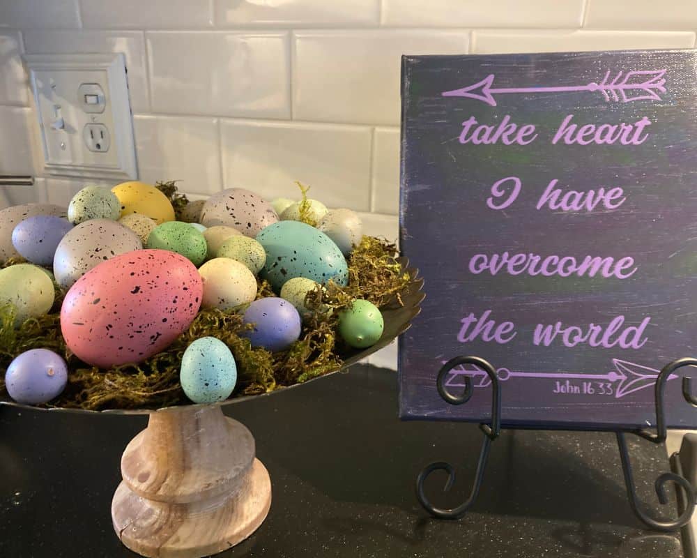 Display of easter eggs and purple sign with John 16:33