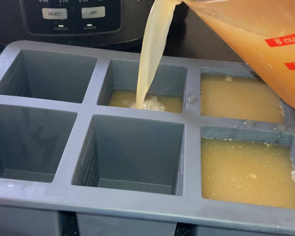 pouring bone broth into silicone molds