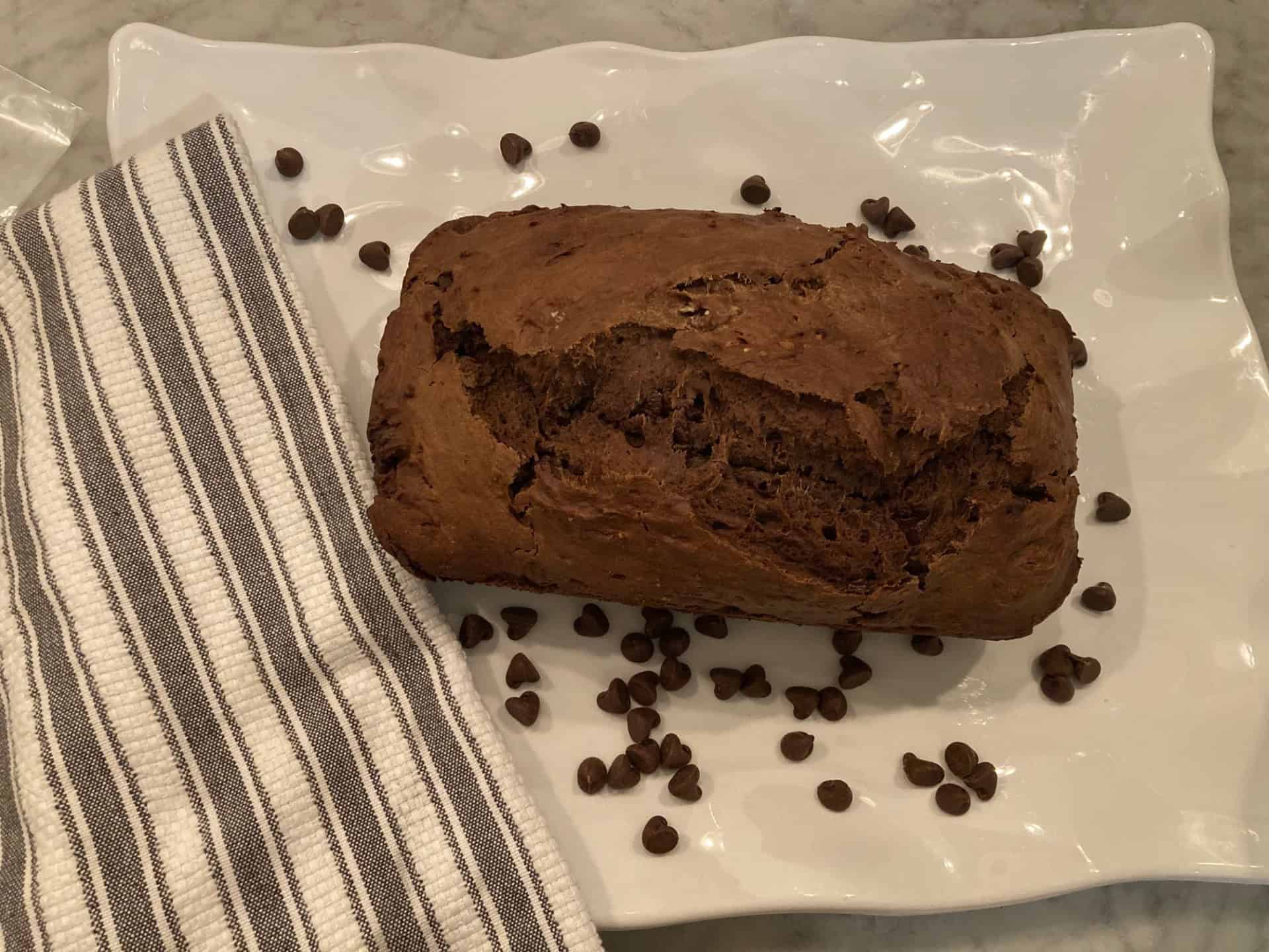 Loaf of chocolate bread on white plate