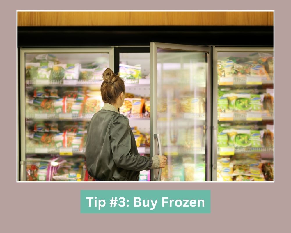 lady opening freezer at grocery store