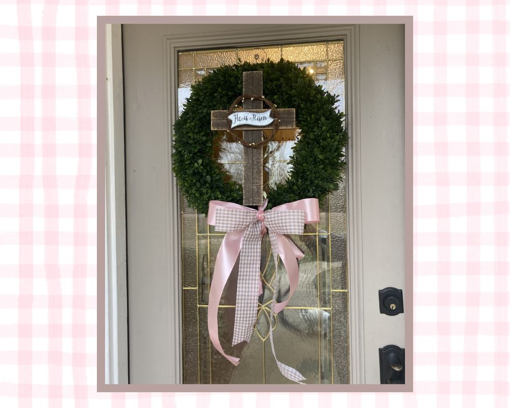 wreath on front door with cross and pink ribbon